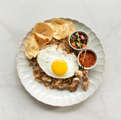 fried rice plate with egg, crackers, and sambal