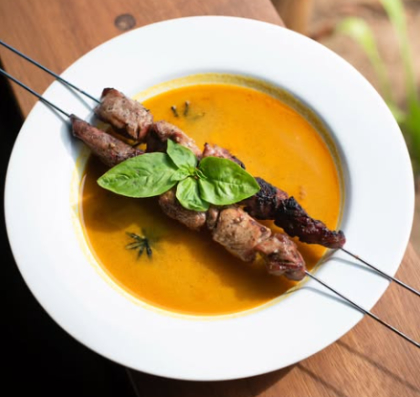 satay skewers over curry sauce