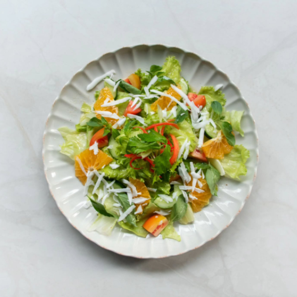 fresh vegetable salad on a white plate