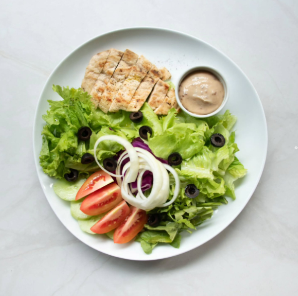 grilled chicken salad plate with greens and dressing