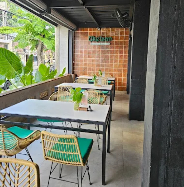 cafe exterior or patio with visible Ukelsan sign and seating